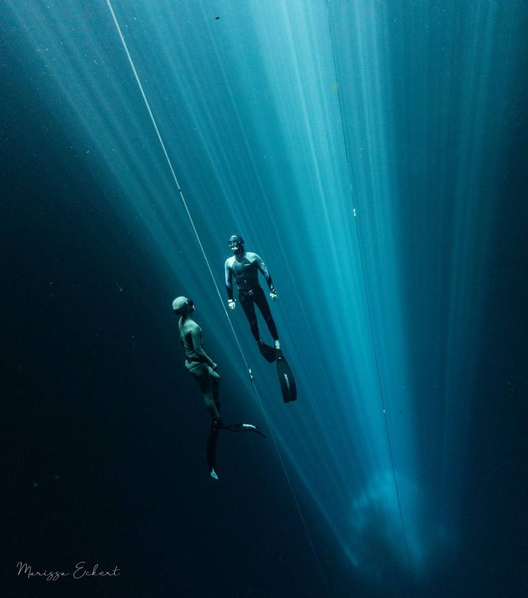 Freedivers on the line inside a cenote