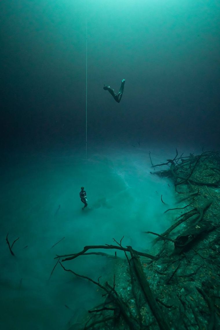 Freediver hovering over the halocline in a Yucatán cenote